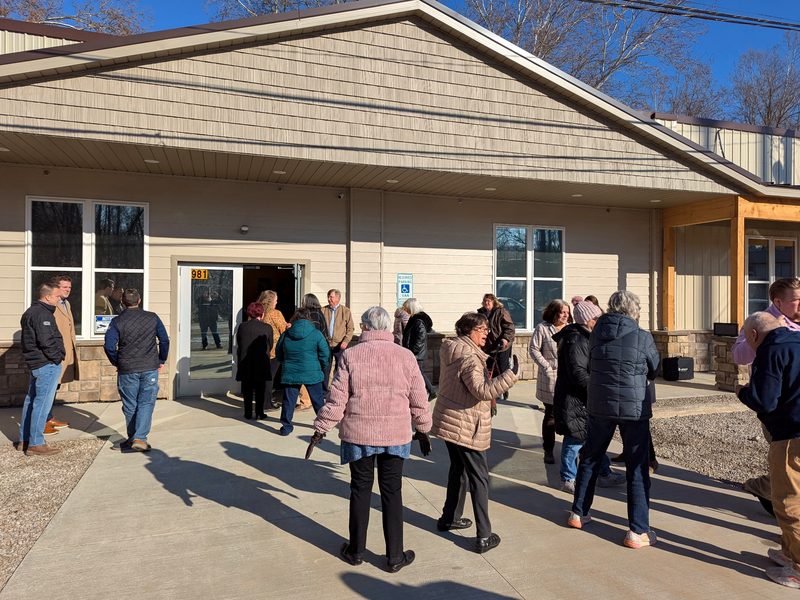 Neighbours arriving on a sunny day for an open house, walking up the path to the shelter entrance.